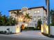 Elegant Mediterranean-style home with palm trees, an arched entry, and manicured landscaping for curb appeal at 4205 Higel Ave, Sarasota, FL 34242