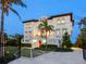 Elegant multi-story home with a gated entrance, lush landscaping, and inviting ambiance at 4205 Higel Ave, Sarasota, FL 34242