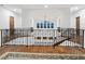 Spacious foyer with hardwood floors, intricate wrought iron railings, and arched windows overlooking the property at 4205 Higel Ave, Sarasota, FL 34242