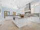Open kitchen with a large island, granite countertops, and stainless steel appliances at 4205 Higel Ave, Sarasota, FL 34242