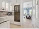 Bright kitchen featuring an in-cabinet wine refrigerator and open access to the dining room at 4205 Higel Ave, Sarasota, FL 34242