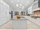 Bright kitchen features custom white cabinets, granite countertops, and a center island at 4205 Higel Ave, Sarasota, FL 34242