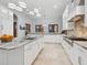 Open kitchen boasts white cabinets, granite countertops, and stainless steel appliances at 4205 Higel Ave, Sarasota, FL 34242