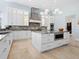 Bright kitchen features white cabinets, marble countertops, and a stainless steel hood at 4205 Higel Ave, Sarasota, FL 34242