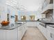 Chef's kitchen boasting custom cabinetry, marble countertops, and stainless steel appliances at 4205 Higel Ave, Sarasota, FL 34242