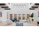 Bright living room with high ceilings, exposed beams, and multiple French doors offering outdoor views at 4205 Higel Ave, Sarasota, FL 34242