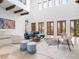 Bright living room with high ceilings, exposed wood beams, arched doorways, and light neutral finishes at 4205 Higel Ave, Sarasota, FL 34242