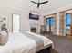 Elegant bedroom with a fireplace, ensuite bathroom, balcony, and plenty of natural light at 4205 Higel Ave, Sarasota, FL 34242
