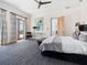 Spacious main bedroom featuring a ceiling fan, soft carpet, and balcony access with beautiful light at 4205 Higel Ave, Sarasota, FL 34242