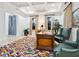 Bright office space with colorful rug, a large desk, and natural light from two windows at 4205 Higel Ave, Sarasota, FL 34242