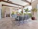 Inviting outdoor living area features a fireplace, comfortable seating, and serene views at 4205 Higel Ave, Sarasota, FL 34242