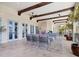 Covered outdoor living space features ceiling fans, a stone fireplace, and comfortable lounge seating at 4205 Higel Ave, Sarasota, FL 34242