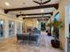 Covered patio featuring wood beams, an outdoor fireplace, and stylish patio furniture at 4205 Higel Ave, Sarasota, FL 34242