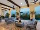 Relaxing covered patio with comfortable furniture overlooking the serene water views at 4205 Higel Ave, Sarasota, FL 34242