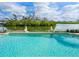 Inviting pool features two statues and overlooks the serene backyard waterfront view at 4205 Higel Ave, Sarasota, FL 34242