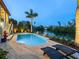 Backyard pool overlooking the canal with lounge chairs for relaxing and enjoying the waterfront view at 4205 Higel Ave, Sarasota, FL 34242