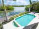 Stunning pool with views of the water, lush landscaping and a private dock at 4205 Higel Ave, Sarasota, FL 34242