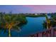 Scenic waterfront view at twilight featuring lush vegetation, water, and distant homes at 4205 Higel Ave, Sarasota, FL 34242