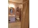 Bathroom with wallpaper, a sink, toilet, walk-in shower, and closet with louvered doors at 4555 Bay Club Dr # 22, Bradenton, FL 34210