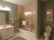 Bathroom with a tub and frosted glass doors, white sink, and tiled floor at 4555 Bay Club Dr # 22, Bradenton, FL 34210