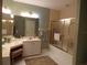 Bright bathroom featuring a vanity, toilet, and shower with gold trim at 4555 Bay Club Dr # 22, Bradenton, FL 34210