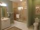 Bright bathroom featuring a vanity, toilet, and shower with gold trim at 4555 Bay Club Dr # 22, Bradenton, FL 34210