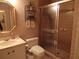 Cozy bathroom featuring sink, toilet and glass-door shower at 4555 Bay Club Dr # 22, Bradenton, FL 34210