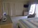 Comfortable bedroom featuring two closet doors, a dresser, and a charming armchair at 4555 Bay Club Dr # 22, Bradenton, FL 34210