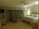 Bright bedroom features a queen bed and a comfortable reading nook with a plush armchair at 4555 Bay Club Dr # 22, Bradenton, FL 34210