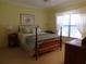 Bedroom with a bed, two side tables, a window, and yellow walls at 4555 Bay Club Dr # 22, Bradenton, FL 34210