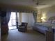 Bedroom with a bed, chair, and a sliding glass door to the lanai at 4555 Bay Club Dr # 22, Bradenton, FL 34210