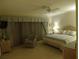 Cozy bedroom with a ceiling fan, bedside lamp, and blue drapes at 4555 Bay Club Dr # 22, Bradenton, FL 34210