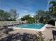 Inviting community pool with lounge chairs and mature landscaping on a sunny day at 4555 Bay Club Dr # 22, Bradenton, FL 34210