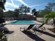 Outdoor community pool featuring lounge chairs, blue water, and a brick pool deck at 4555 Bay Club Dr # 22, Bradenton, FL 34210