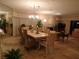 An open-concept dining room and living room featuring tile floors, a chandelier, and comfortable seating at 4555 Bay Club Dr # 22, Bradenton, FL 34210
