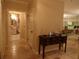 Hallway with tile floors, a dark wood table with drawers, and a view to the living room and bathroom at 4555 Bay Club Dr # 22, Bradenton, FL 34210