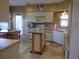 Bright kitchen featuring white cabinets, center island, and a cozy breakfast nook at 4555 Bay Club Dr # 22, Bradenton, FL 34210