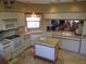 A well-lit kitchen offers white cabinetry, modern appliances, and a movable island perfect for meal preparation at 4555 Bay Club Dr # 22, Bradenton, FL 34210