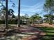 Beautifully landscaped walkway featuring brick pavers, lush greenery, and tall palm trees at 4555 Bay Club Dr # 22, Bradenton, FL 34210