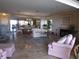 Open-concept living area featuring tile floors, a fireplace, large windows, and water views at 4555 Bay Club Dr # 22, Bradenton, FL 34210