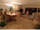 Spacious living room with a fireplace, tile floors, and a dining area with chandelier at 4555 Bay Club Dr # 22, Bradenton, FL 34210