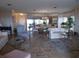 Spacious living room featuring tile floors, furniture, and access to the dining area at 4555 Bay Club Dr # 22, Bradenton, FL 34210