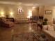 Cozy living room featuring tile floors, multiple sofas, lamps and a glass coffee table at 4555 Bay Club Dr # 22, Bradenton, FL 34210