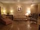 Comfortable living room featuring tile floors, sofa, lamps, painting, and neutral tones at 4555 Bay Club Dr # 22, Bradenton, FL 34210