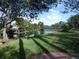 Scenic view of a tranquil pond surrounded by lush greenery and trees in a well-maintained community at 4555 Bay Club Dr # 22, Bradenton, FL 34210