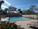 Community pool with lounge chairs and a nearby hot tub provides the perfect relaxation spot at 4555 Bay Club Dr # 22, Bradenton, FL 34210
