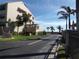 Exterior view of building behind lush landscaping under a bright sky at 4555 Bay Club Dr # 22, Bradenton, FL 34210