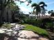 Exterior walkway showcasing green lawns and lush landscaping on a bright, sunny day at 4555 Bay Club Dr # 22, Bradenton, FL 34210