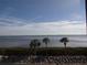 Scenic water view featuring palm trees, lush greenery, and a tranquil bay at 4555 Bay Club Dr # 22, Bradenton, FL 34210