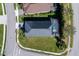 Aerial shot of the residence showcasing the roof, screened-in pool, and well-maintained lawn at 4706 Roycroft Ter, Parrish, FL 34219